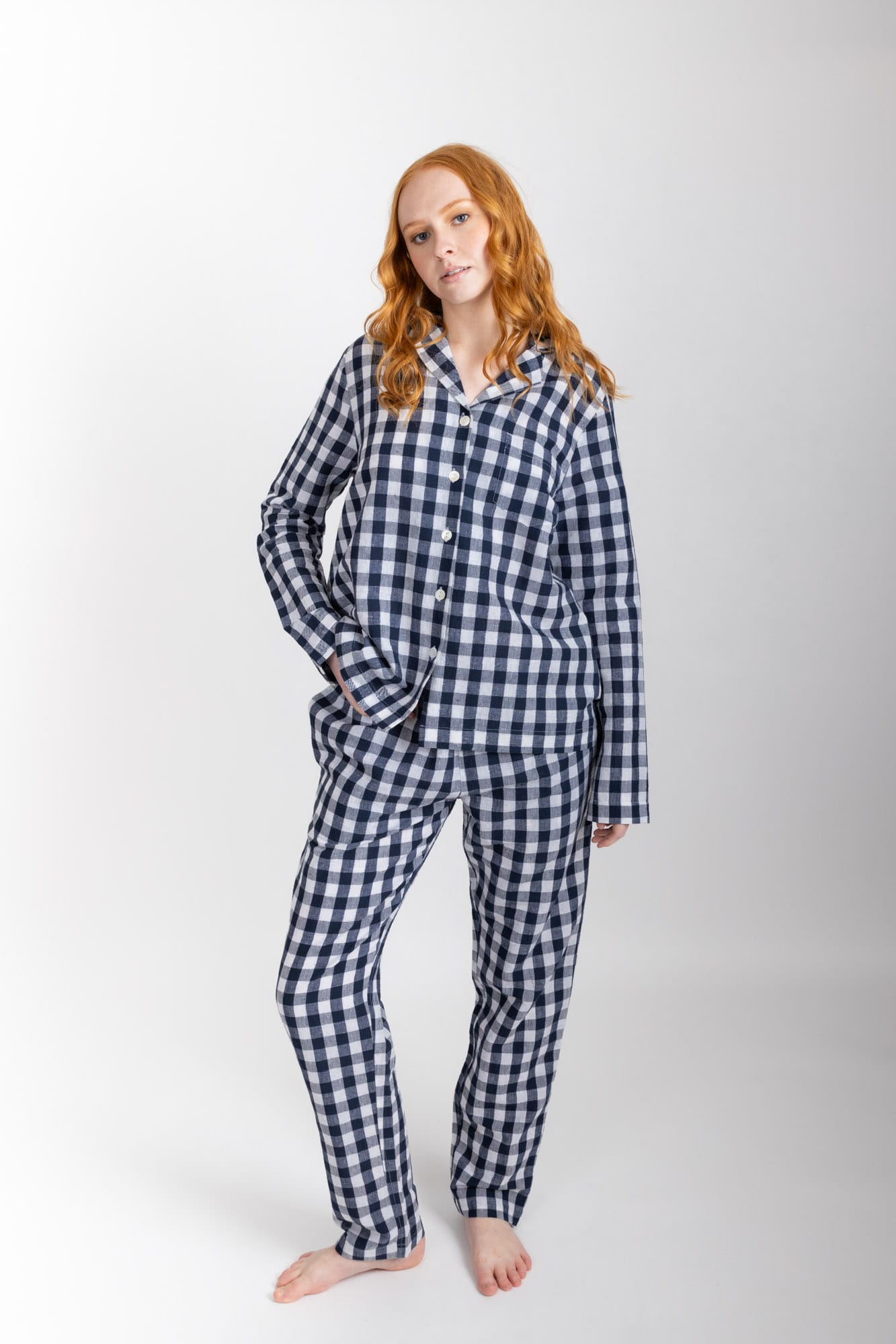 Women’s pyjama set including a long sleeve shirt and long sleeve pants. Made from an organic cotton and linen blend, in a Navy check.  The shirt has shell buttons, a front pocket and a back pleat.  The pants feature an elasticated waistband for comfort.