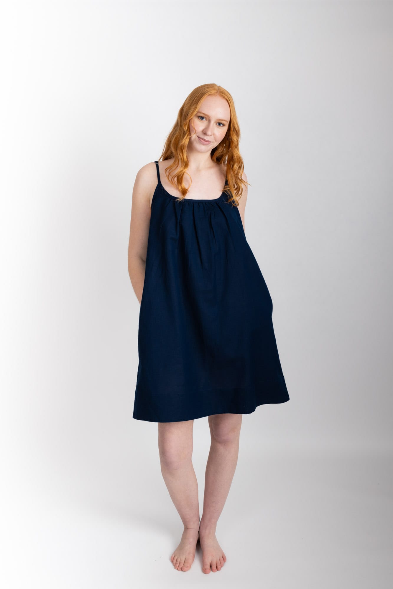 This knee length women’s nightdress dress features a scoop neck, adjustable spaghetti straps and side pockets. Finished with a wide hem, French seams, it is made from an organic cotton and linen blend, in Navy